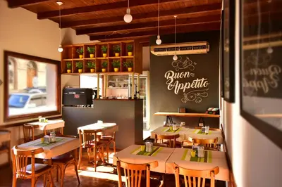 a dining room with tables and chairs in a restaurant at Gran Rex Hotel in Cordoba