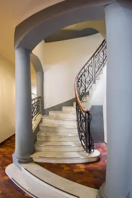a staircase in a house with an archway at Gran Rex Hotel in Cordoba