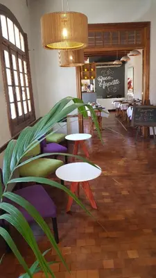 a restaurant with tables and chairs and a plant at Gran Rex Hotel in Cordoba