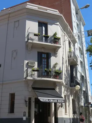 a white building with balconies and a sign on it at Gran Rex Hotel in Cordoba