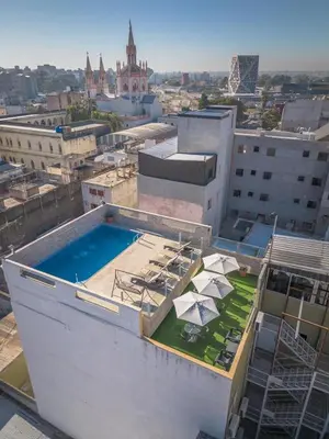 a building with a swimming pool on top of it at Hotel Everest in Cordoba