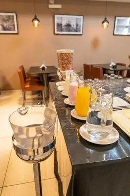a restaurant with plates and glasses on a counter at Hotel Everest in Cordoba