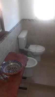 a bathroom with a toilet and a sink at Sierra Magenta in Los Hornillos