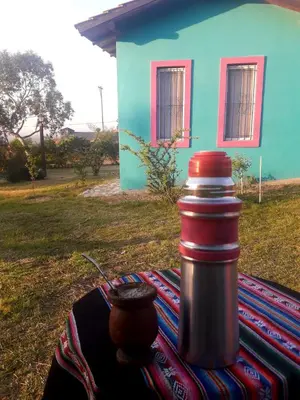a thermos sitting on a table in front of a house at Sierra Magenta in Los Hornillos