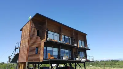 a wooden house on a dock with a blue sky at Amatxi in Los Reartes