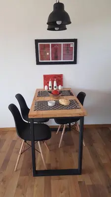a dining room table with chairs and aendant light at Amatxi in Los Reartes