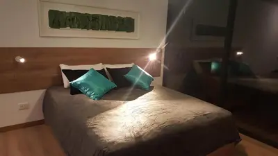 a bedroom with a bed with blue and white pillows at Amatxi in Los Reartes