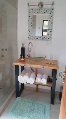 a bathroom with a sink and a counter with towels at Amatxi in Los Reartes