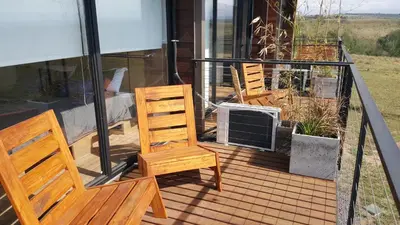 two chairs and an air conditioner on a deck at Amatxi in Los Reartes