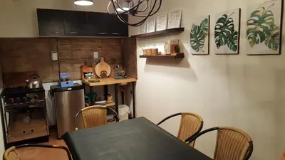 a kitchen with a table and chairs and a refrigerator at Amatxi in Los Reartes