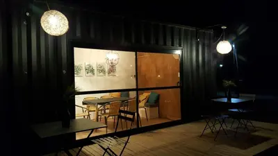 a dining room with a table and chairs and lights at Amatxi in Los Reartes