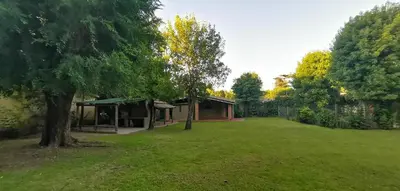a house in the middle of a yard with a tree at Villa Elena Icho Cruz in Villa Icho Cruz