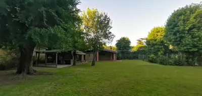 a large yard with a house and a tree at Villa Elena Icho Cruz in Villa Icho Cruz