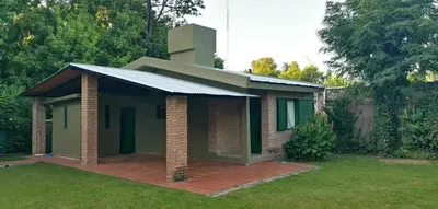a small green building with a brick patio at Villa Elena Icho Cruz in Villa Icho Cruz