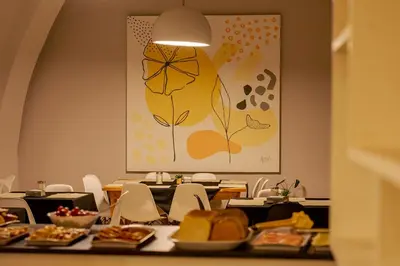 a dining room with a table with plates of food at Riviera Hotel & Spa in Villa Carlos Paz