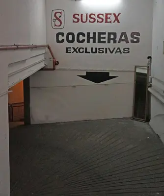 an empty room with a sign on the wall at Hotel Sussex in Cordoba