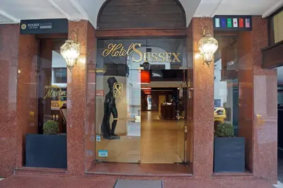 a store front with a woman in the window at Hotel Sussex in Cordoba