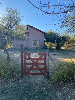 a wooden gate in front of a house at Antiguo Molle in Merlo