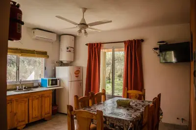 a kitchen with a table and a refrigerator at Antiguo Molle in Merlo