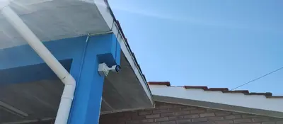 a blue door on a building with a roof at Blacky House in Villa Carlos Paz