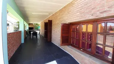 a hallway of a building with a brick wall at Blacky House in Villa Carlos Paz
