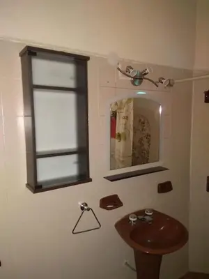 a bathroom with a wooden sink and a window at Blacky House in Villa Carlos Paz