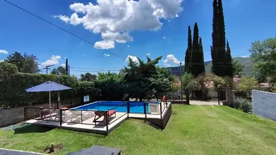 a swimming pool in the backyard of a house at Blacky House in Villa Carlos Paz