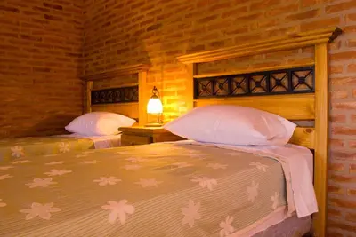 a bedroom with two beds in a room at Lauquen Pilmaiquen y spa in Merlo