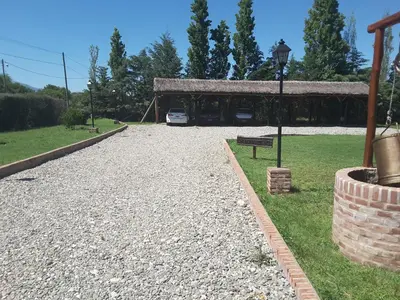 a park with a car parked in front of a building at Lauquen Pilmaiquen y spa in Merlo