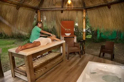 a woman laying on a bed in a room with a tub at Lauquen Pilmaiquen y spa in Merlo