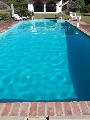 a large blue swimming pool in a yard at La casita en la Juni in San Javier
