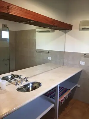 a bathroom counter with a sink and a mirror at La casita en la Juni in San Javier