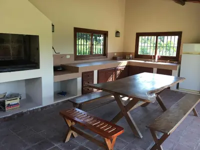 a kitchen with a wooden table and a wooden bench at La casita en la Juni in San Javier