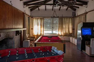 a living room with a pool table and a tv at Hotel Parque Siquiman in Villa Carlos Paz