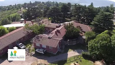 an aerial view of a house with trees at Hotel Parque Siquiman in Villa Carlos Paz