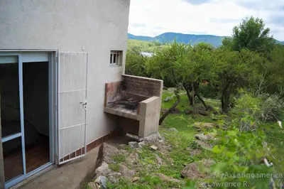 a building with an open door next to a window at Cabañas Alma de Pueblo, Mayu Sumaj in San Antonio de Arredondo