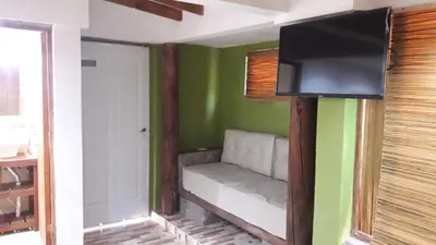 a room with a couch with a tv on the wall at Altos del Molle SF in San Francisco del Monte de Oro