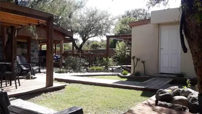 a backyard with a deck and a house at Altos del Molle SF in San Francisco del Monte de Oro