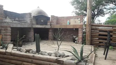 a garden with a brick building with a fireplace at Altos del Molle SF in San Francisco del Monte de Oro