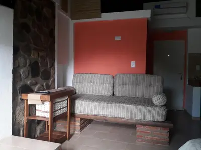 a living room with a couch and a table at Altos del Molle SF in San Francisco del Monte de Oro