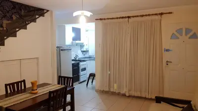 a kitchen and dining room with a dining table and a dining room at Duplex a mts del Rio con Aire Acond in Villa Carlos Paz