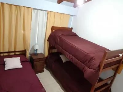 a bedroom with two bunk beds in a room at Duplex a mts del Rio con Aire Acond in Villa Carlos Paz