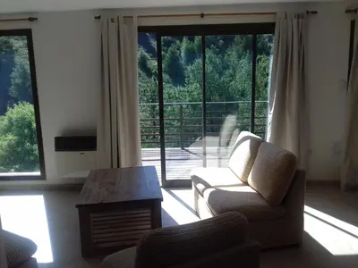 a living room with a couch and a table at Casa en La Cumbrecita in La Cumbrecita