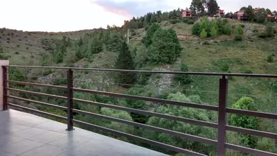 a balcony with a view of a mountain at Casa en La Cumbrecita in La Cumbrecita