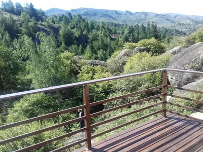 a balcony with a view of the mountains at Casa en La Cumbrecita in La Cumbrecita