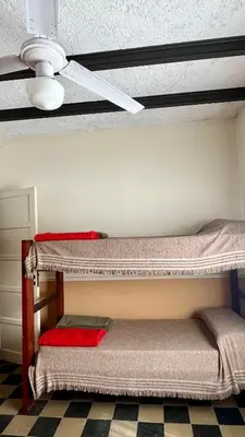two bunk beds in a room with a ceiling at Casa en el centro in Villa Cura Brochero
