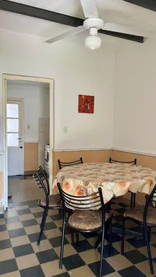 a dining room with a table and chairs and a ceiling at Casa en el centro in Villa Cura Brochero