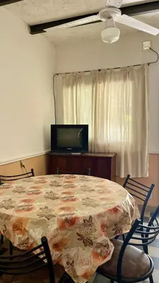 a dining room with a table with a flowered table cloth at Casa en el centro in Villa Cura Brochero