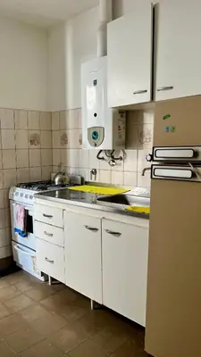 a kitchen with a sink and a stove at Casa en el centro in Villa Cura Brochero