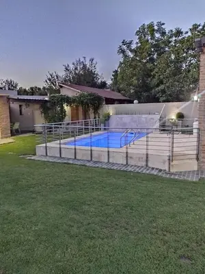 a swimming pool in the backyard of a house at Las Cuatro Estaciones in Villa Cura Brochero